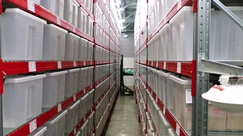 Robot in warehouse moves plastic containers Stock Footage 202310524