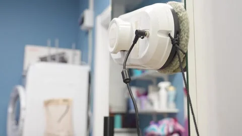 Robot washer vacuum cleaner rides on the mirror in the hallway and washes it Stock Footage 321418539