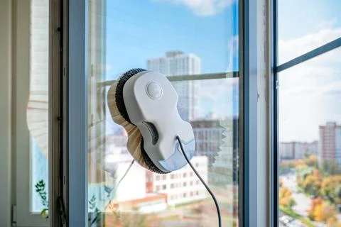 Robot window cleaner adhering to a high-rise apartment window. Autonomously 스톡 사진
