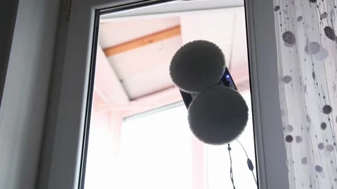 Robot window cleaner device moving on window glass pane clean automatic modern Stock Footage 329213347