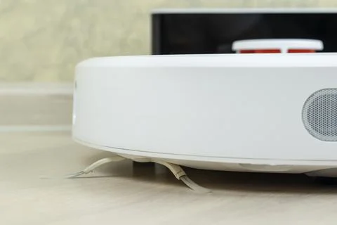 Robot wireless vacuum cleaner working on the floor Photos