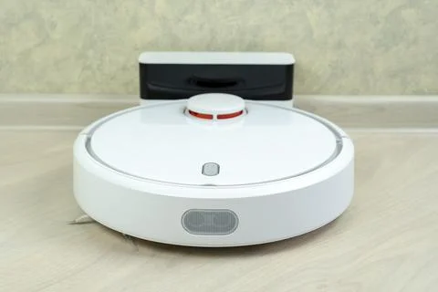 Robot wireless vacuum cleaner working on the floor Stock Photos