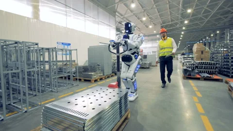 A robot works at a warehouse with a human, close up. Stock Footage 92681926