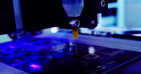 A robotic arm applying solder paste on a circuit board. Stock Footage 336556566