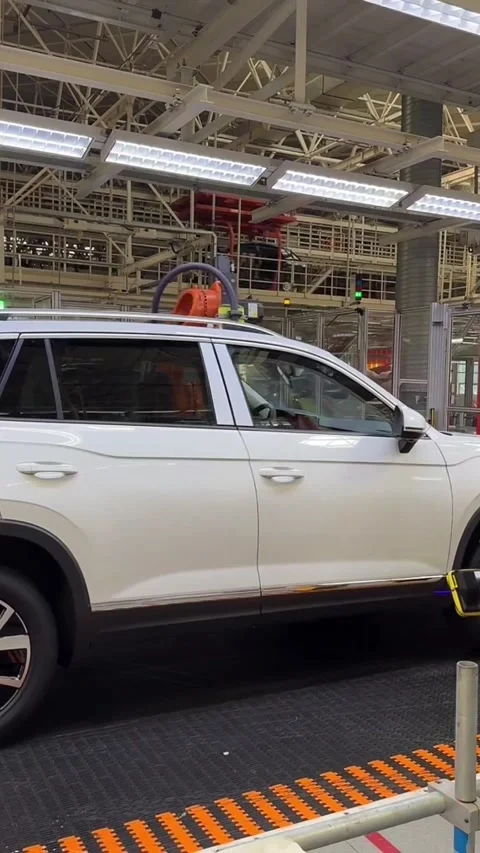 Robotic Arm Assembling New Energy Vehicle (NEV) in Modern Chinese Factory Stock Footage 337802637