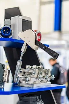 Robotic arm assembly line, gray and blue color palette, scattered electronic  Stock Photos