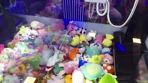 Robotic arm choosing a soft toy randomly from a vending machine. Claw Stock Footage 256017238