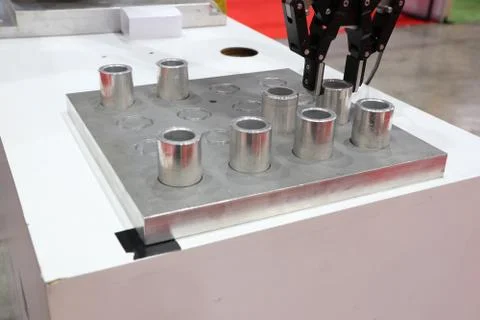Robotic arm clamp sample and transfer in metal plate Stock Photos