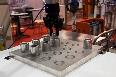 Robotic arm clamp sample and transfer in metal plate Stock Photos