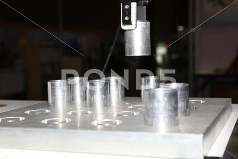 Robotic arm clamp sample and transfer in metal plate Stock Photos