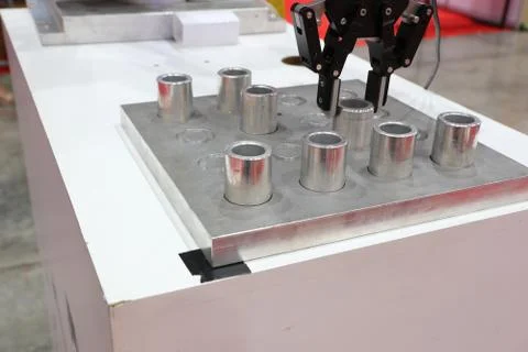 Robotic arm clamp sample and transfer in metal plate Stock Photos