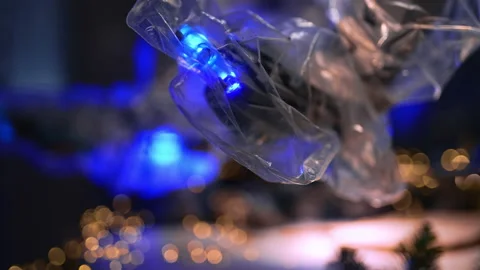 Robotic arm coated with plastic with lights on top moves working. Stock Footage 221109466