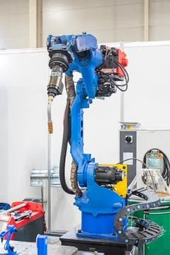 Robotic arm in commercial environment, featuring blue color scheme, red and.. Stock Photos