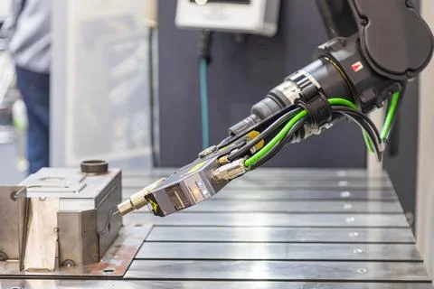 Robotic arm equipped with precision tool over metallic workbench, emphasizi.. Stock Photos