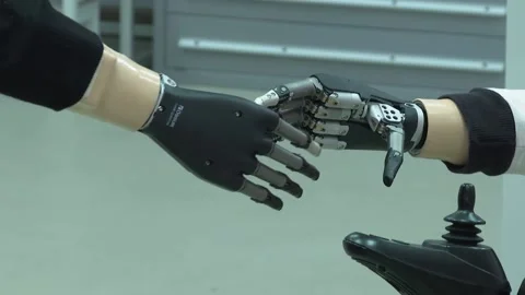 Robotic-arm Hand Prosthesis shakes human and robot's hand Stock Footage 232161824