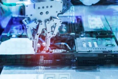 Robotic arm installing a computer chip with cpu Stock Photos