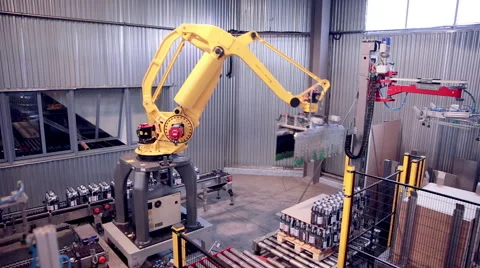 Robotic Arm Loading and assembling products Stock Footage 64373135