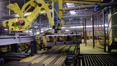 Robotic Arm Loading products. Automated machinery in action Stock Footage 73351340