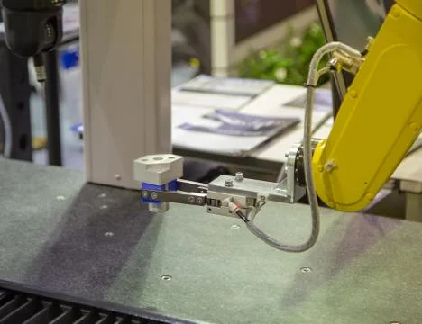 Robotic arm loading workpiece to CMM machine Stock Photos