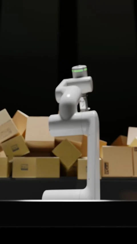 A robotic arm loads boxes onto a conveyor belt and sorts the boxes for shipment. Video stock 265902819