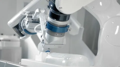 Robotic arm makes an injection with chemotherapy medicine. Two manipulators Stock Footage 123294903