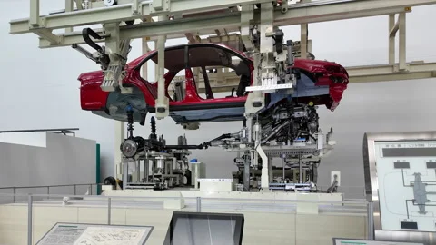 Robotic arm making car in line at Toyota Motor Museum Stock Footage 310051977