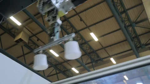 Robotic arm manipulator with suction cups moves plastic containers: close up Stock Footage 341849621