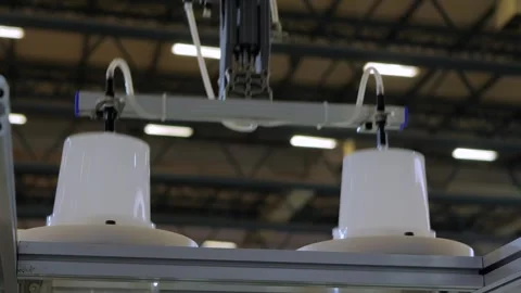 Robotic arm manipulator with suction cups moves white plastic containers Stock Footage 341854890