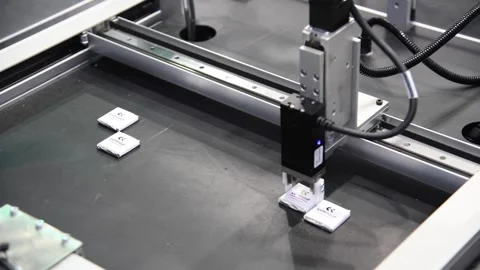 Robotic arm moves small chocolates Stock Footage 292283979