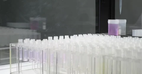 Robotic arm pours purple liquid into test tubes. Scientific laboratory of Stock Footage 265592833