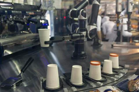 Robotic arm preparing coffee in coffee machine Stock Photos