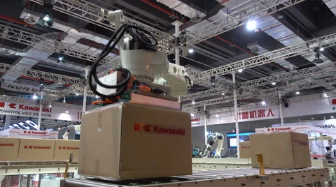 Robotic arm puts boxes on conveyor belt at trade show Shanghai Stock Footage 67545824