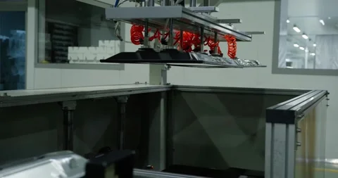 A robotic arm stacks computer monitors on a conveyor belt. A large workshop for Stock Footage 281480351