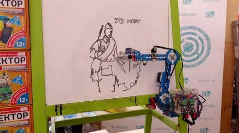 Robotic arm use felt pen to draw sketch picture on piece of paper, science fair Stock Footage 65485931