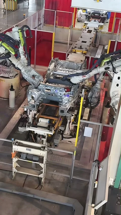 Robotic Arms Assembling Car Body Frame in Modern Automotive Factory China Stock Footage 339689458