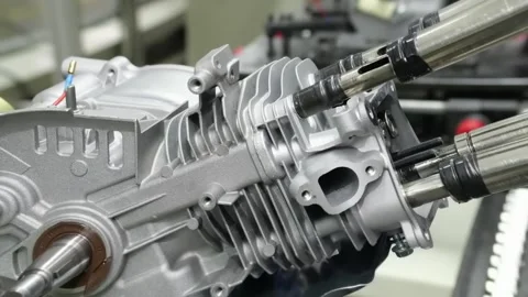 Robotic Arms Assembling Silver Air-Cooled Engine Cylinder Head 動画素材 348591032
