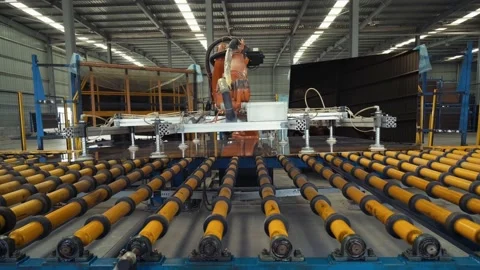 Robotic arms automatically take flat glass from a conveyor line  and place Stock Footage 211803802