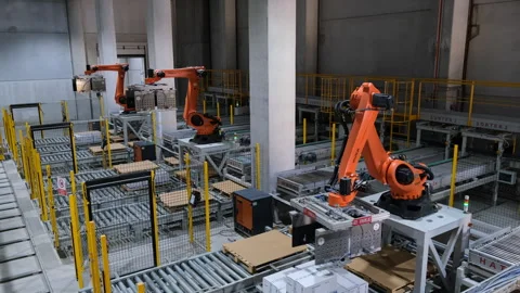Robotic arms efficiently handling packages in a warehouse environment Stock Footage 325324970