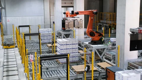 Robotic arms efficiently handling packages in a warehouse environment Stock Footage 325334319