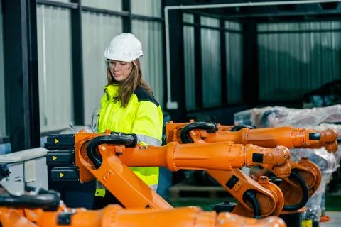 Robotic assembly line technician operates machinery in a modern industrial .. Stock Photos