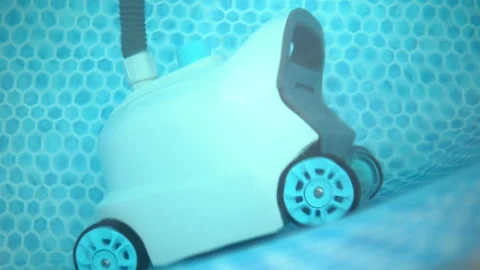Robotic Automatic Pool Vacuum Cleaner Cleaning an Above Ground Stockbeeldmateriaal 343894780