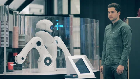 Robotic barista serving a man in a robot cafe Video stock 140634945