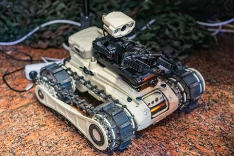 Robotic demining vehicle on display, featuring a light-colored chassis and bl Stock Photos