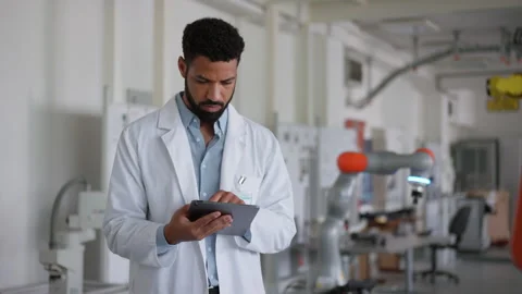 Robotic engineer calibrating or adjusting robotic arm, controlling its actions Stock Footage 277209778