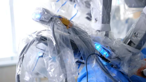 Robotic equipment covered in plastic moves operating the patient Stock Footage 301393146