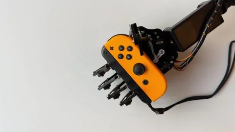 Robotic Hand Grabbing Nintendo Switch Controller Stock Footage 277307196