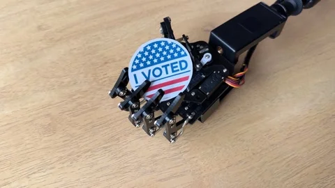 Robotic Hand Holding I Voted Sticker Stock Footage 289401232
