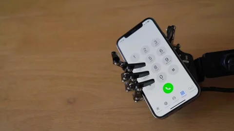Robotic Hand Holding Iphone With Dial Screen Stock Footage 247677429