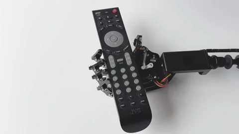 Robotic Hand Holding Remote Control Stock Footage 277307210