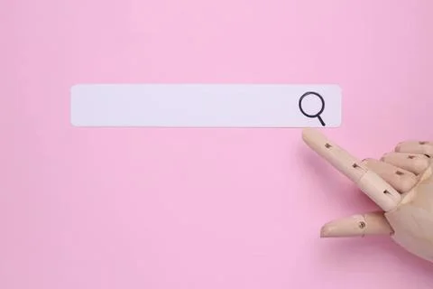 Robotic hand pointing at search bar on pink background 스톡 사진
